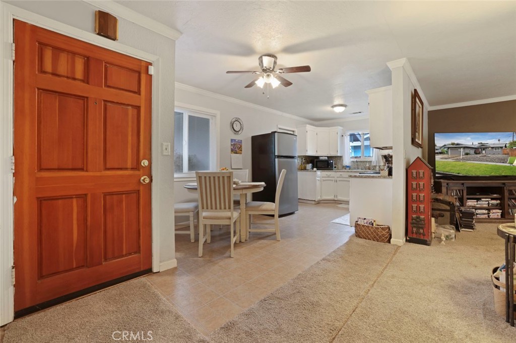 424 Morada Lane Stockton, CA 95210 - Photo 21 of 51 a view of a livingroom with furniture a flat screen tv wooden floor and a ceiling fan