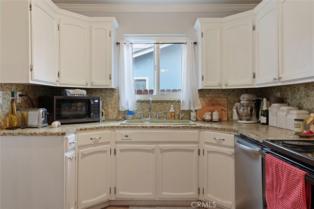 424 Morada Lane Stockton, CA 95210 - Photo 25 of 51 a kitchen with white cabinets and white appliances