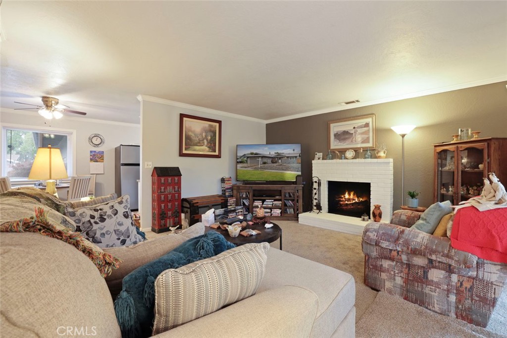 424 Morada Lane Stockton, CA 95210 - Photo 29 of 51 a living room with furniture a fireplace and a painting