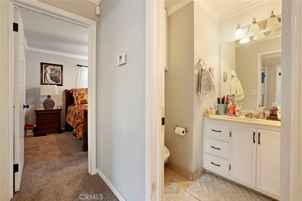 424 Morada Lane Stockton, CA 95210 - Photo 9 of 51 a en suite bathroom with a sink a mirror and a shower