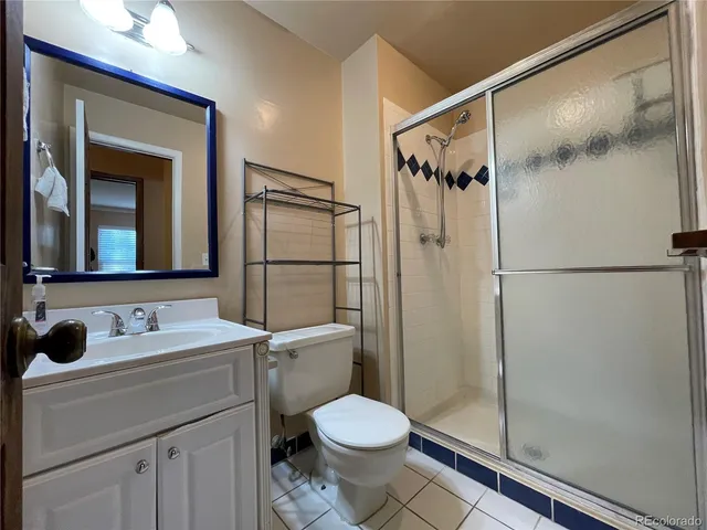 a bathroom with a toilet sink and shower