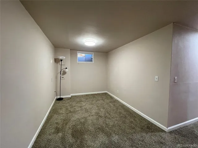 a view of an empty room and a bathroom