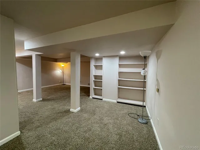 an empty room with an empty space and windows