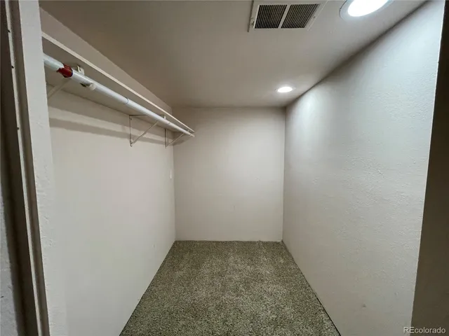 a view of an empty room with stairs and ventilation