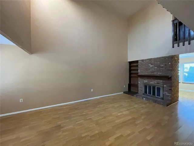 a view of an empty room with a fireplace