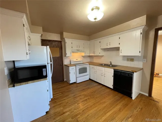 a kitchen with stainless steel appliances a stove a microwave and a refrigerator