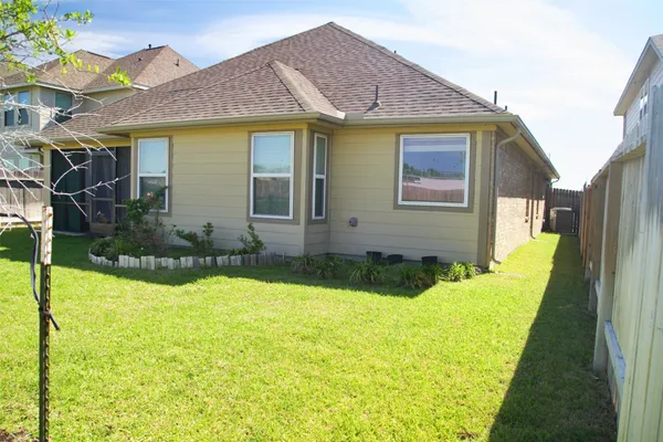 a view of house with yard and swimming pool