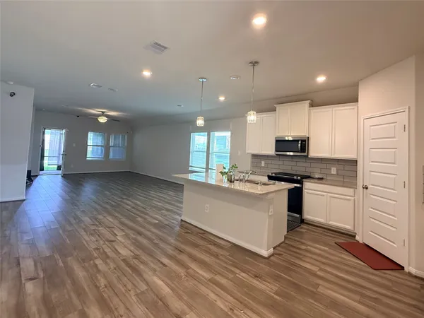 a kitchen with stainless steel appliances a refrigerator sink and stove