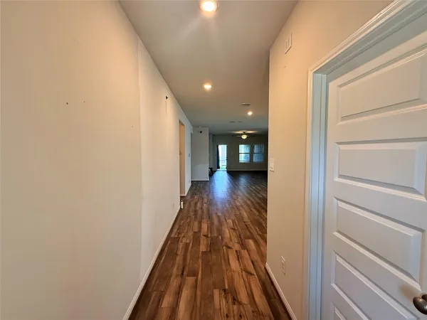 a view of hallway with wooden floor