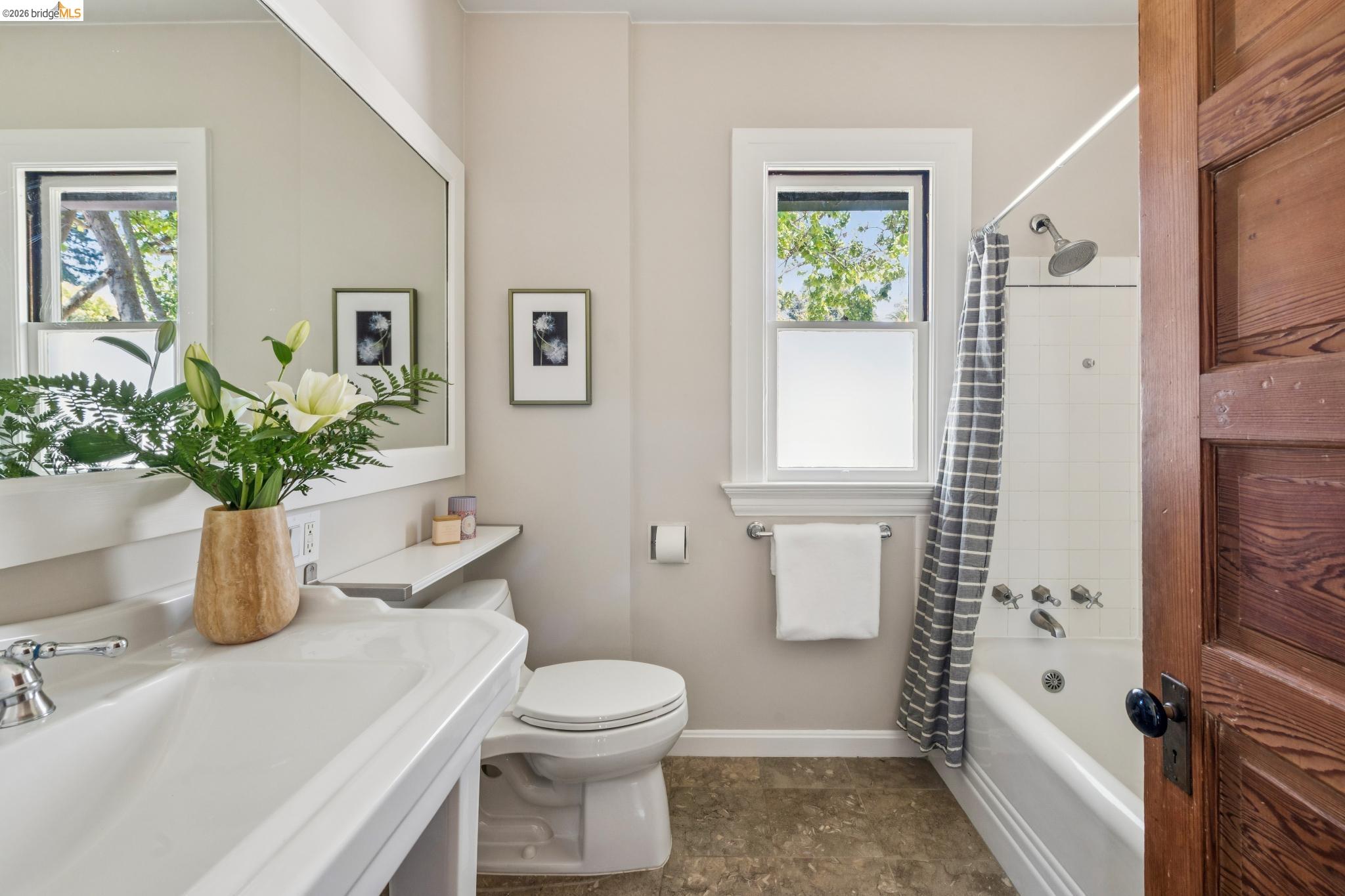 1490 Arch Street Berkeley, CA 94708 - Photo 31 of 57 a bathroom with a toilet a sink and a window