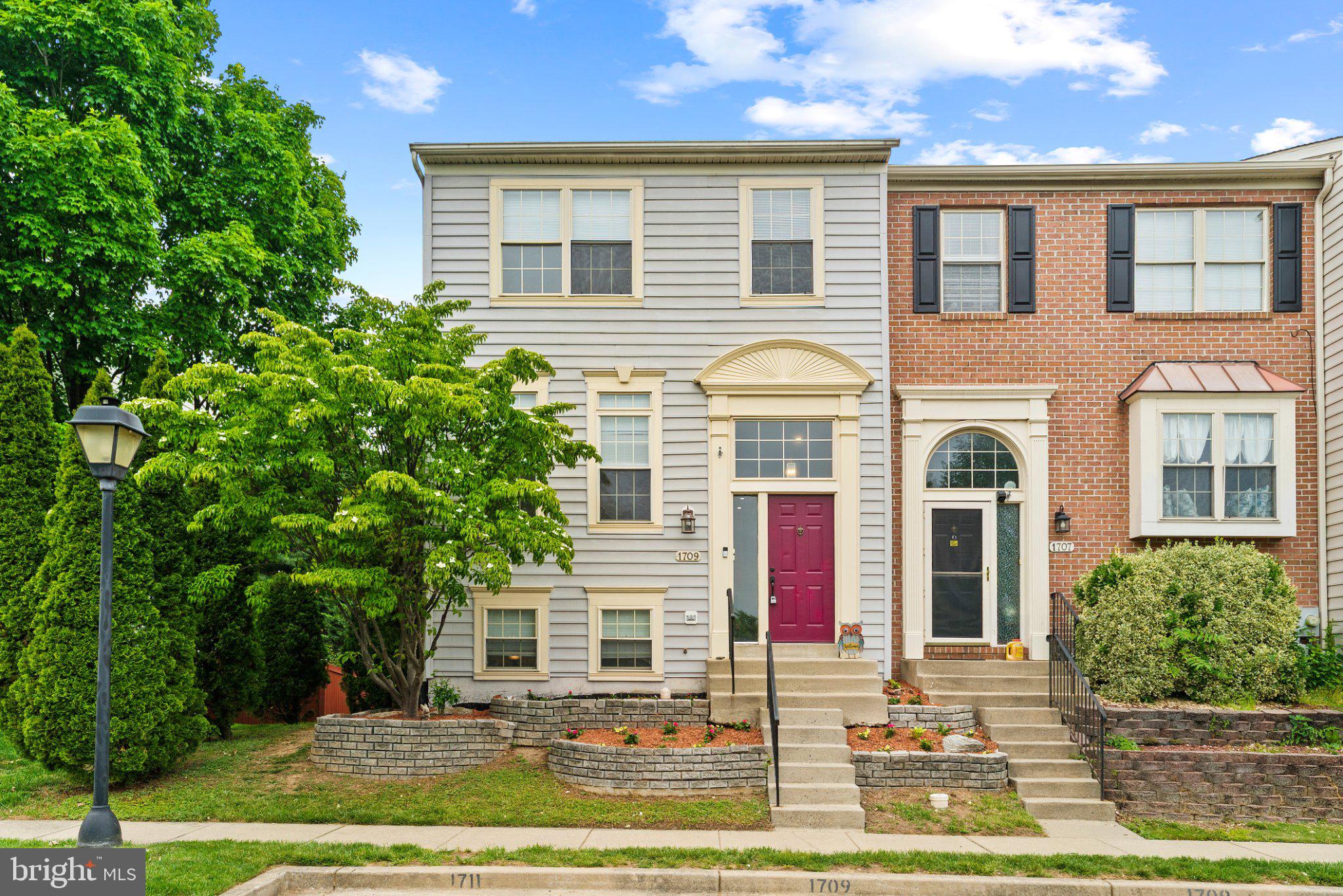 1709 Woodruff Way Frederick, MD 21701 - Photo 2 of 42 front view of residential houses with yard