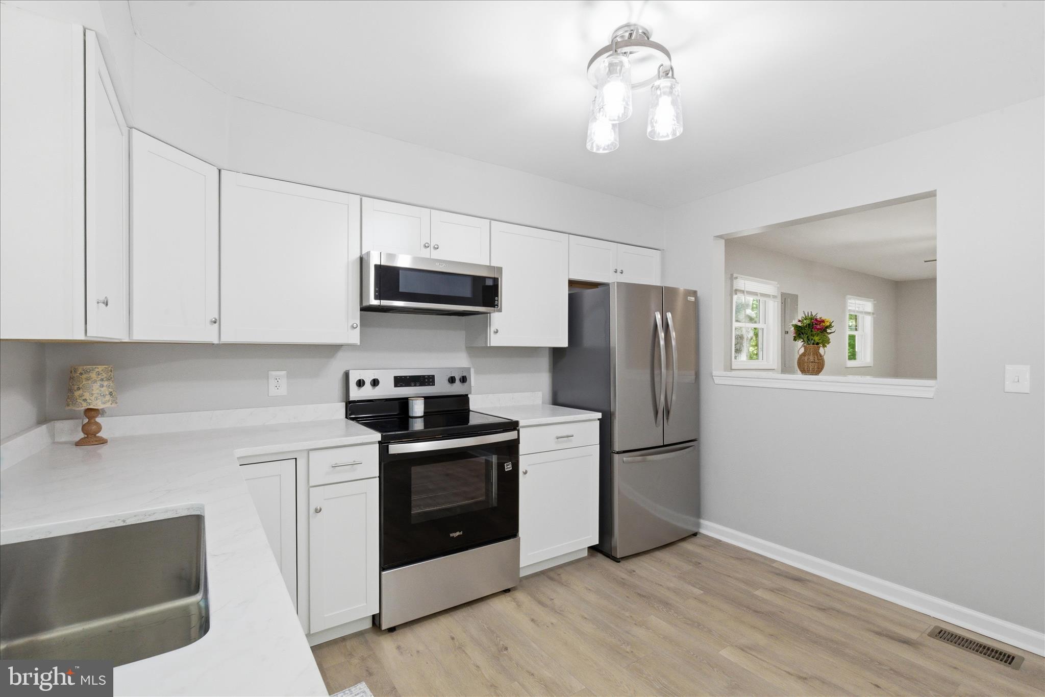 6815 Marshall Road St. Leonard, MD 20685 - Photo 12 of 43 a kitchen with stainless steel appliances granite countertop a refrigerator stove and sink