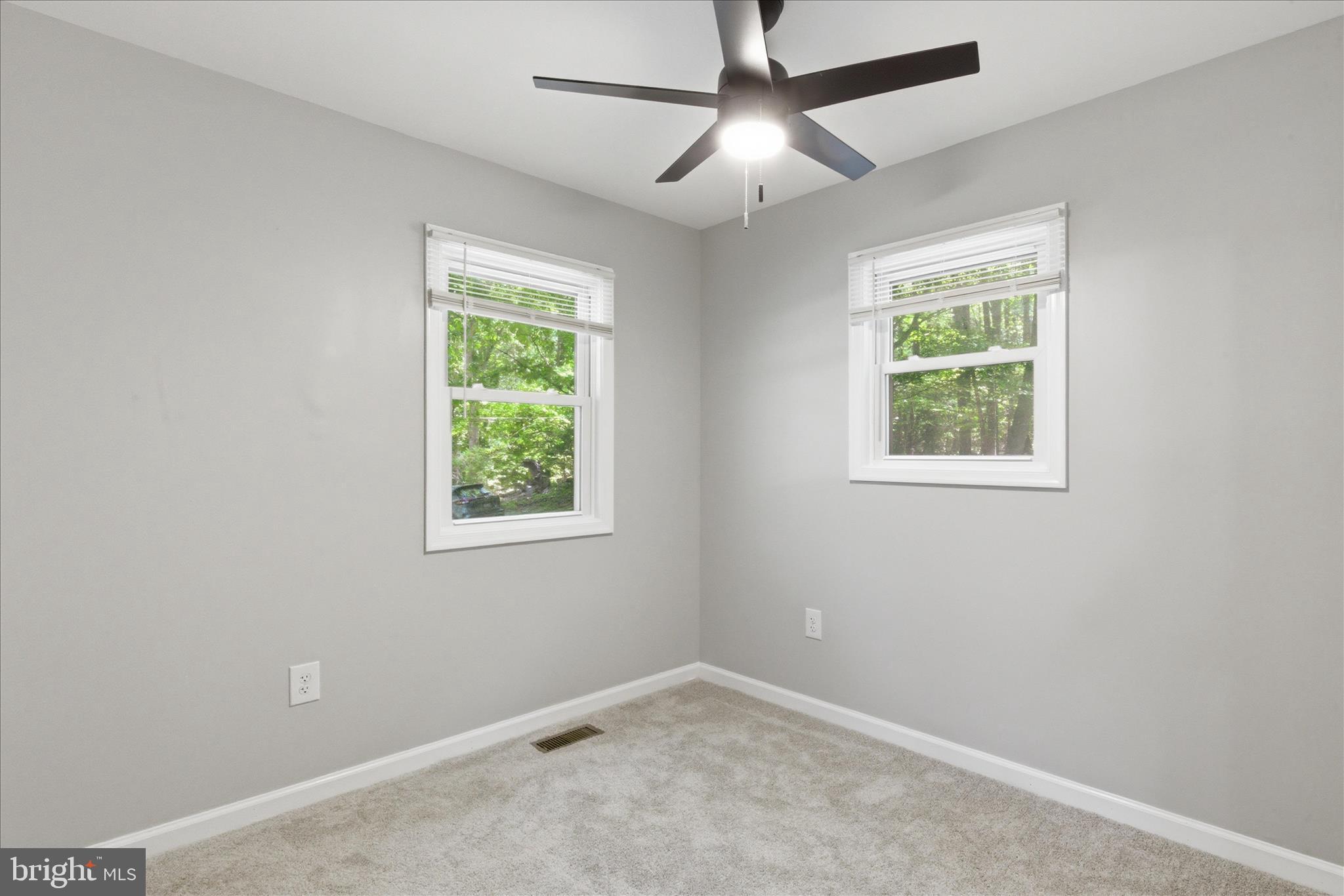 6815 Marshall Road St. Leonard, MD 20685 - Photo 23 of 43 an empty room with a window and a fan