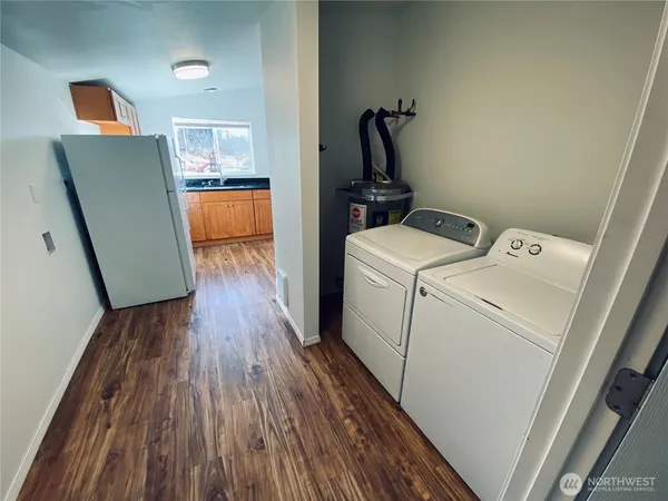 a view of a storage and utility room with washer and dryer