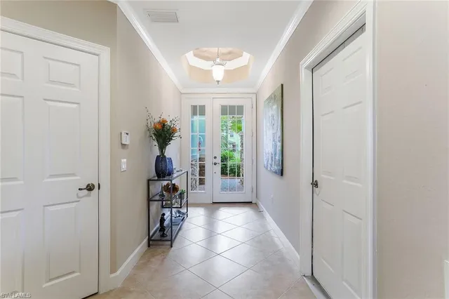 a hallway with windows and chandelier