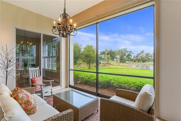 a living room with couch and a floor to ceiling window
