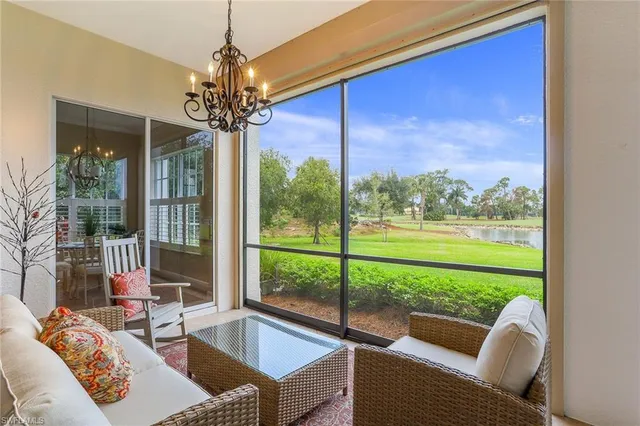 a living room with couch and a floor to ceiling window