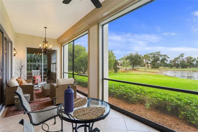 a view of a porch with furniture and a yard