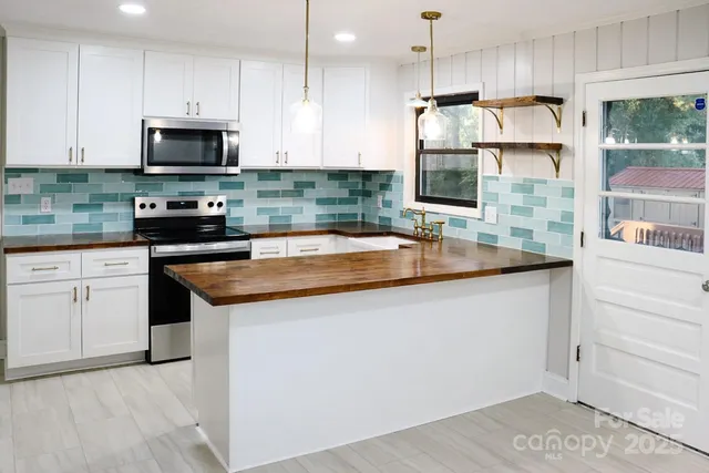 a kitchen with granite countertop a stove and a sink with granite countertops