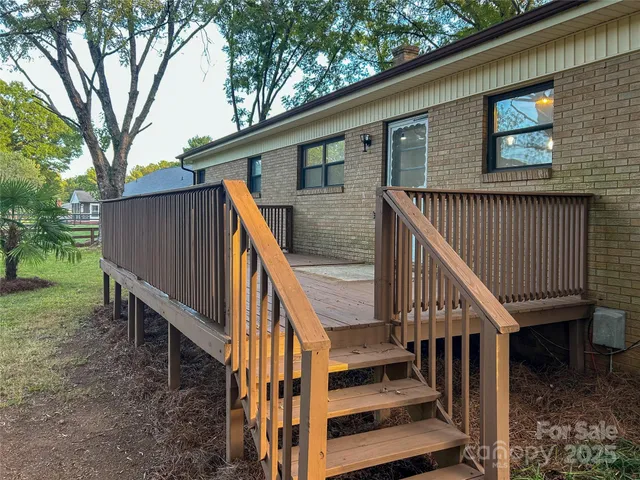 a view of a house with backyard and deck