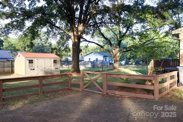 a view of backyard with deck and a garden