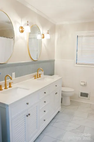 a bathroom with a double vanity sink and a mirror