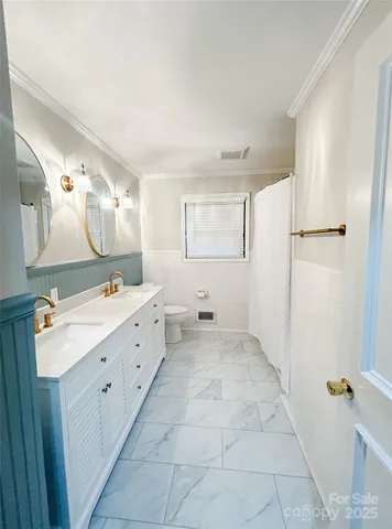 a spacious bathroom with a double vanity sink a mirror and a shower