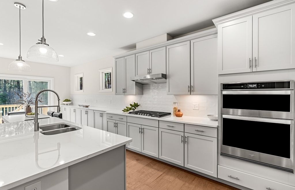 25 Sandtrap Circle, Unit 8 Walpole, MA 02081 - Photo 4 of 15 a kitchen with white cabinets and appliances