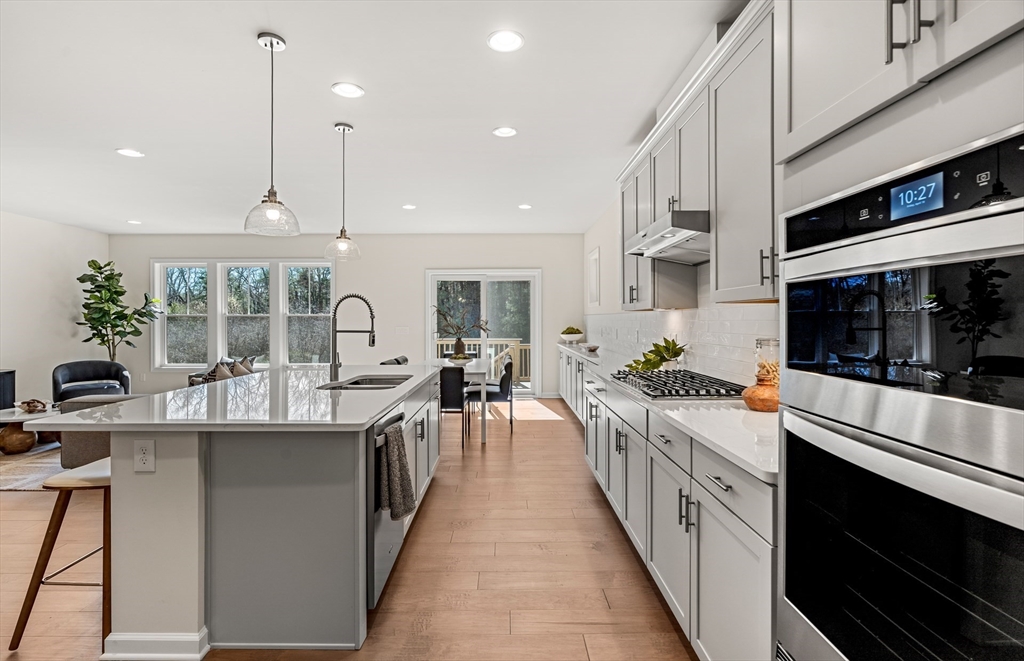 25 Sandtrap Circle, Unit 8 Walpole, MA 02081 - Photo 5 of 15 a kitchen with stainless steel appliances a stove top oven