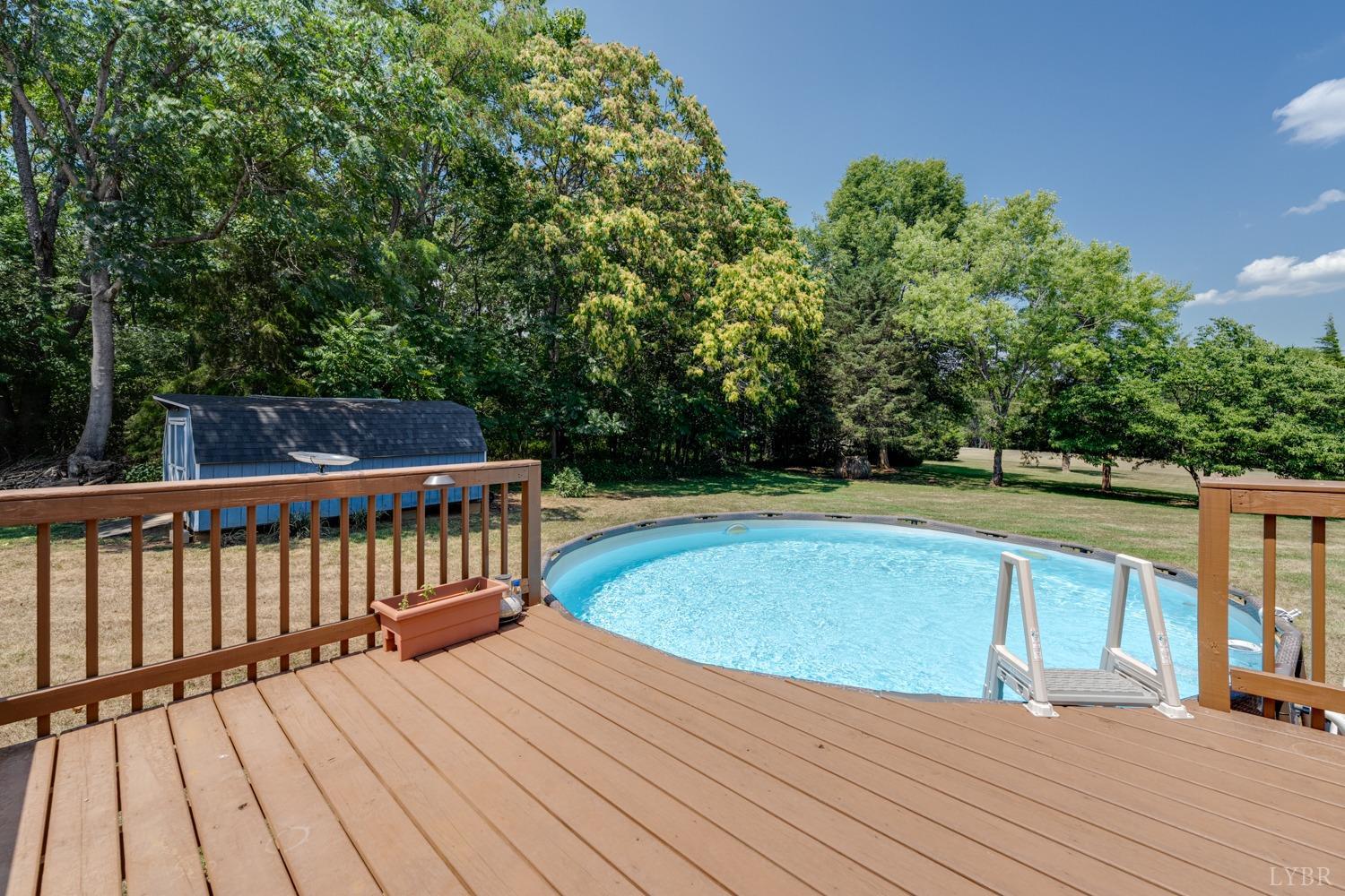 2085 Goode Road Goode, VA 24556 - Photo 54 of 67 a view of balcony with wooden floor and trees in the background