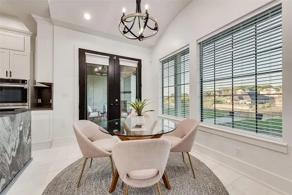 a dining room with furniture window and wooden floor