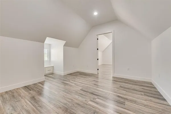 a view of an empty room and wooden floor