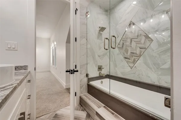 a bathroom with a bathtub and a shower
