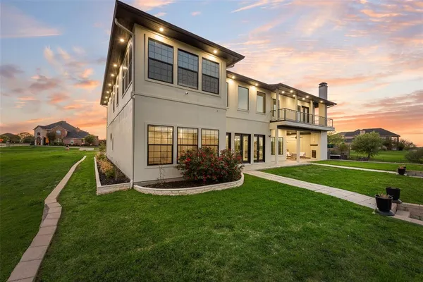 a view of a house with a yard and sitting area
