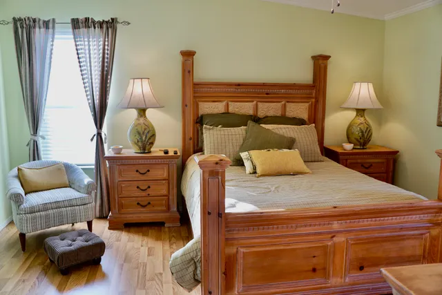 a bedroom with furniture and wooden floor