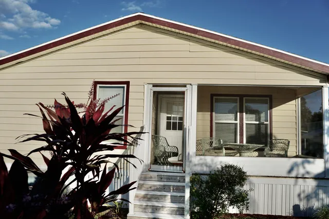 a view of a house with a small yard and plants