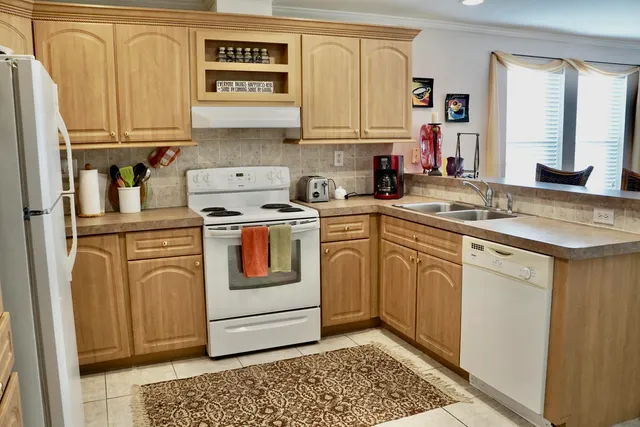 a kitchen with stainless steel appliances granite countertop a sink and cabinets