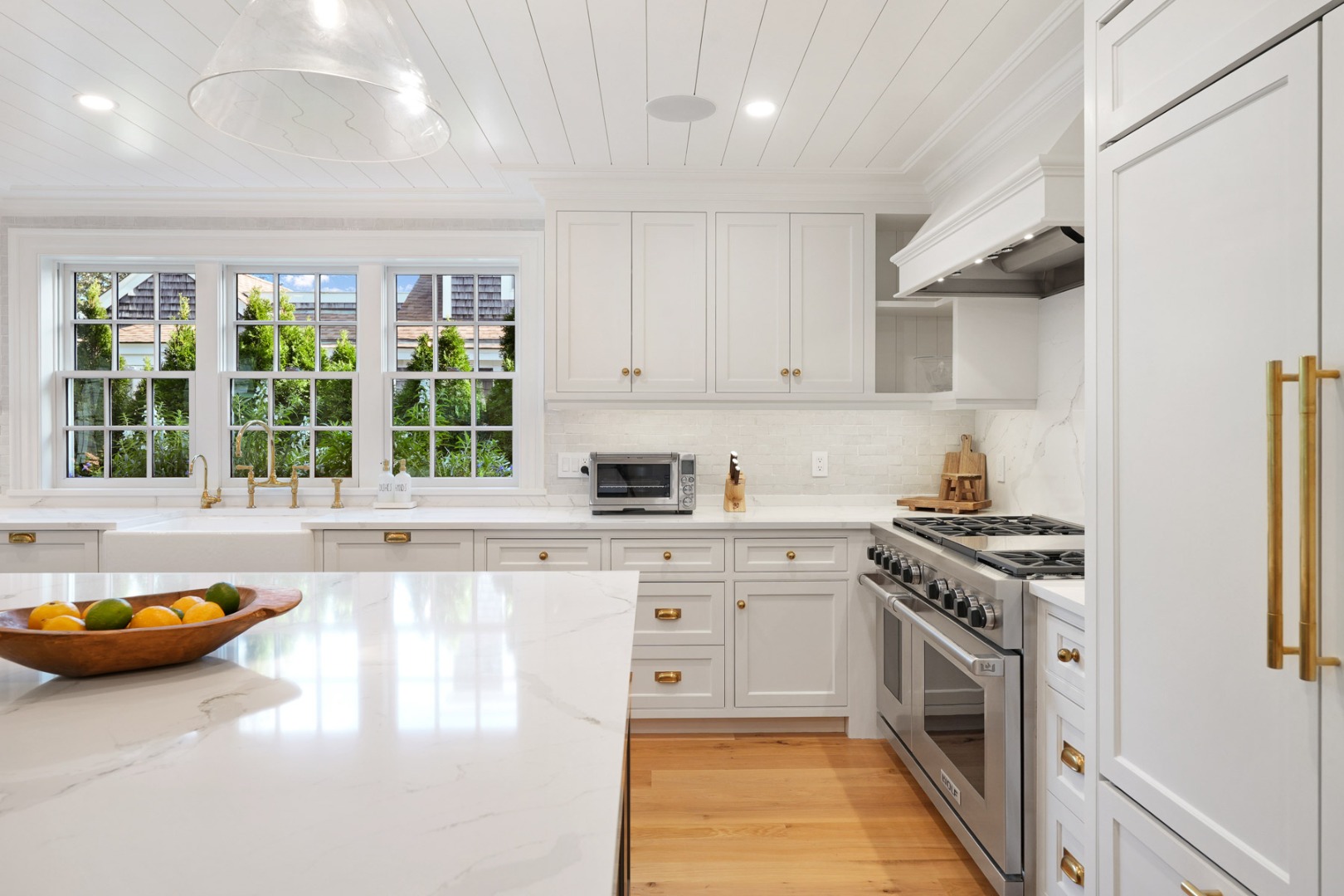 56 North Summer Street Edgartown, MA 02539 - Photo 13 of 77 a kitchen with a stove and a white wooden cabinets