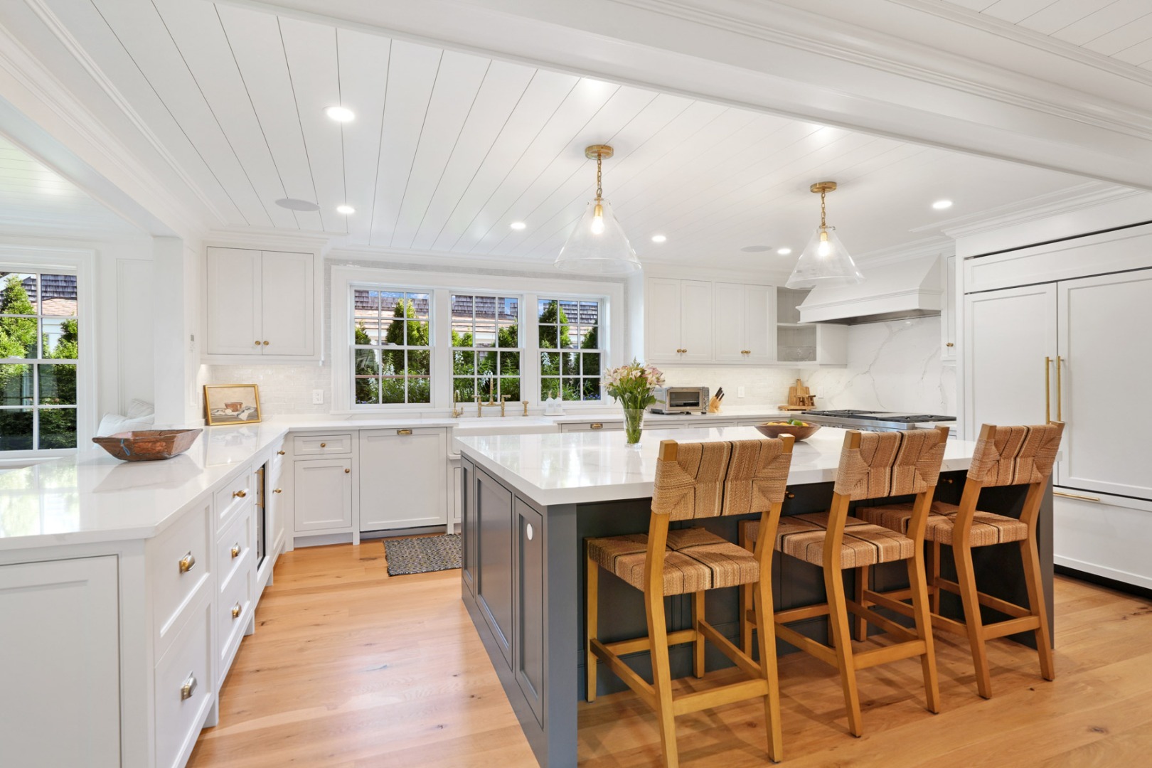 56 North Summer Street Edgartown, MA 02539 - Photo 16 of 77 a kitchen with stainless steel appliances kitchen island granite countertop a table chairs sink and cabinets