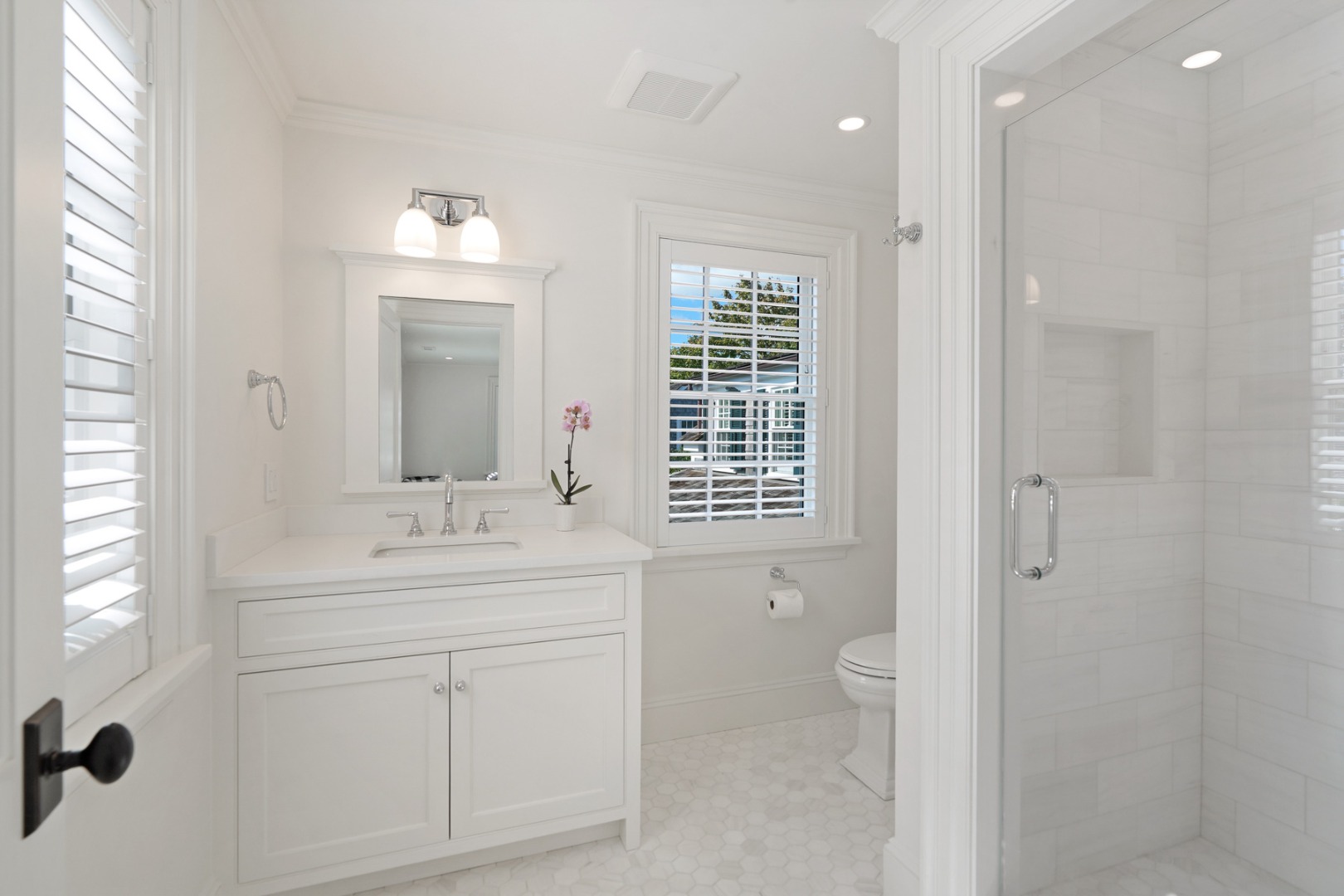 56 North Summer Street Edgartown, MA 02539 - Photo 51 of 77 a bathroom with a double vanity sink a toilet and a mirror