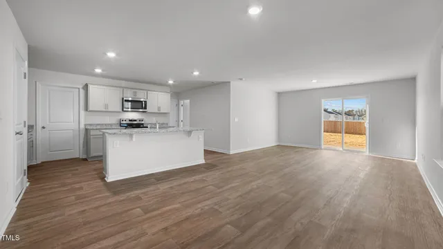a view of a kitchen with a sink and a refrigerator