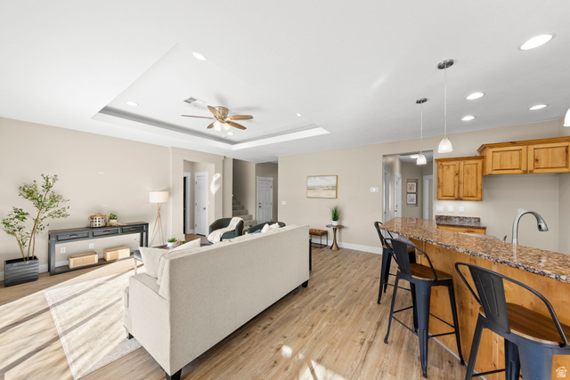 1570 South Rio Virgin Drive Washington, UT 84780 - Photo 16 of 71 Living room with ceiling fan, light wood-type flooring, recessed lighting, and a tray ceiling