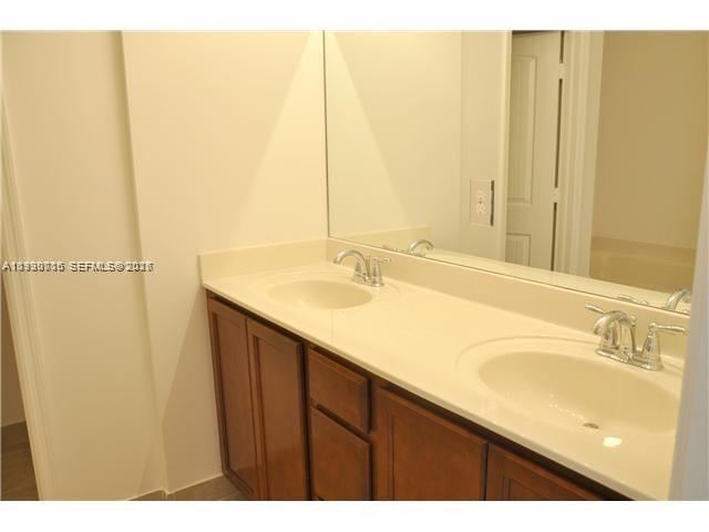 Homestead Homestead, FL 33033 - Photo 17 of 19 a bathroom with a sink and a mirror