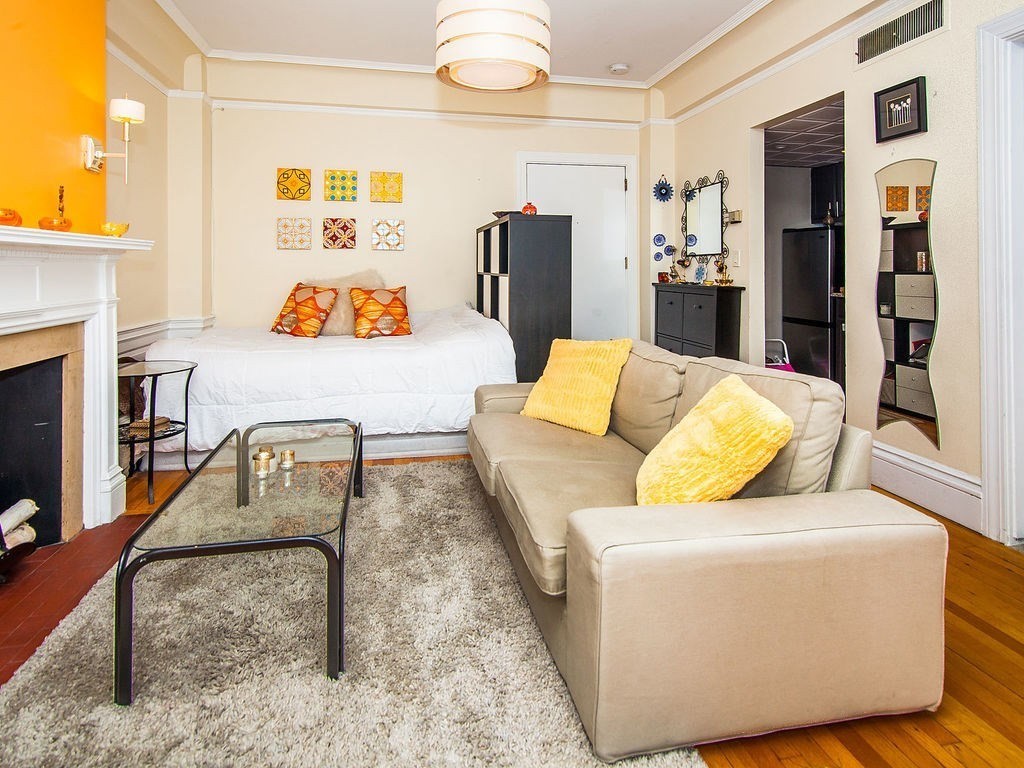 464 Commonwealth Avenue, Unit 36 Boston, MA 02215 - Photo 4 of 18 a living room with furniture and a fireplace