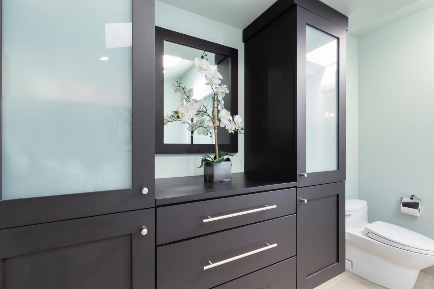 36 Tobin Clark Drive Hillsborough, CA 94010 - Photo 36 of 50 a bathroom with a toilet a sink and mirror