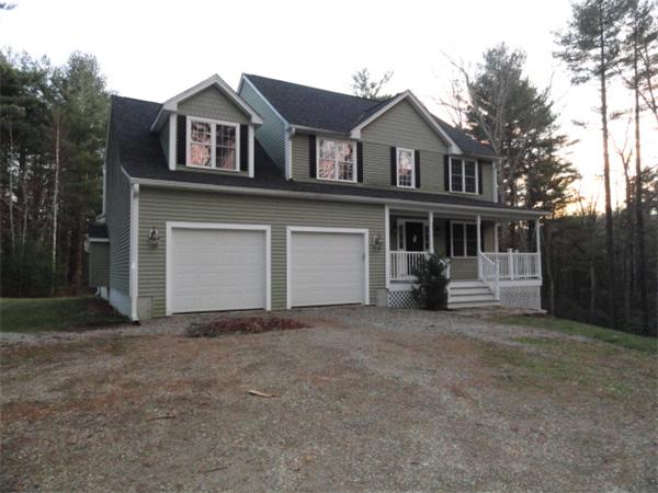 9 Vinton Road Sturbridge, MA 01566 - Photo 1 of 12 a front view of a house with a yard and garage
