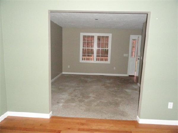 9 Vinton Road Sturbridge, MA 01566 - Photo 7 of 12 a view of an empty room with wooden floor and a window