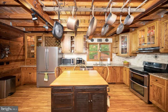a kitchen with granite countertop a refrigerator and a sink