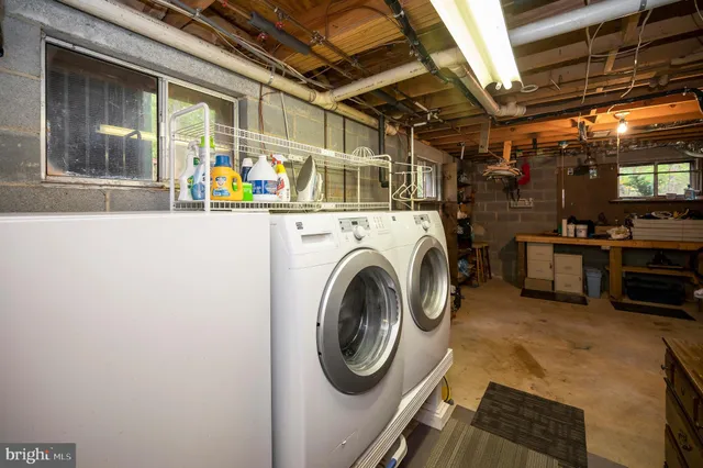 a view of a small barn with wooden fence