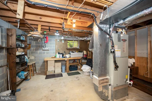 a view of a house with a yard and large tree